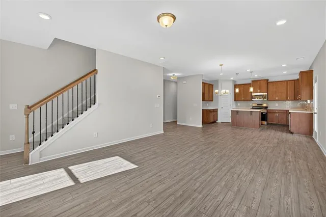 a view of kitchen with wooden floor and electronic appliances