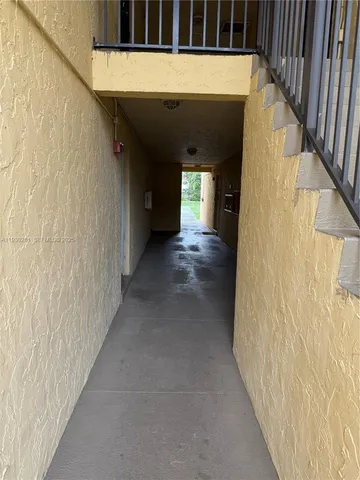 a view of a hallway with wooden shelves
