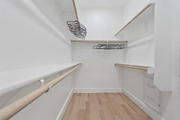 a view of walk in closet with empty racks