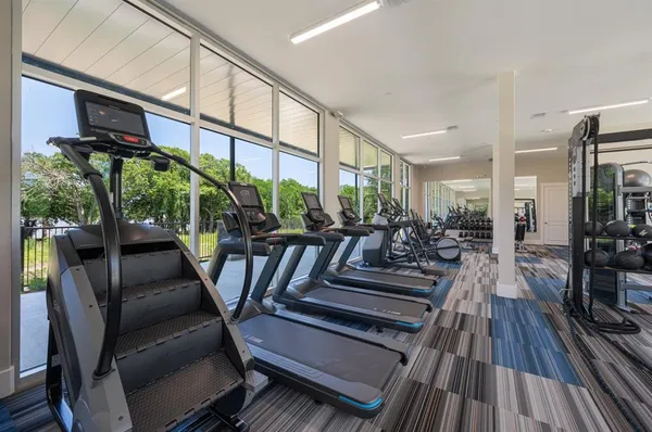 a room with lots of wooden furniture wooden floor and a rug