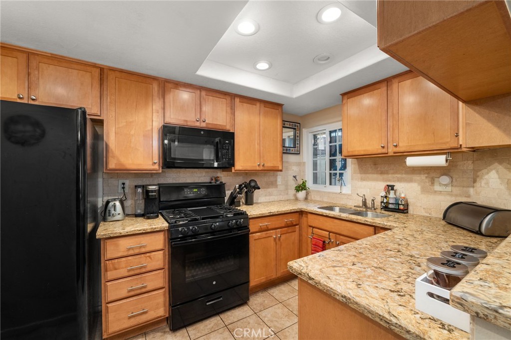 8576 Creekside Place Rancho Cucamonga, CA 91730 - Photo 12 of 37 a kitchen with a sink a stove and refrigerator