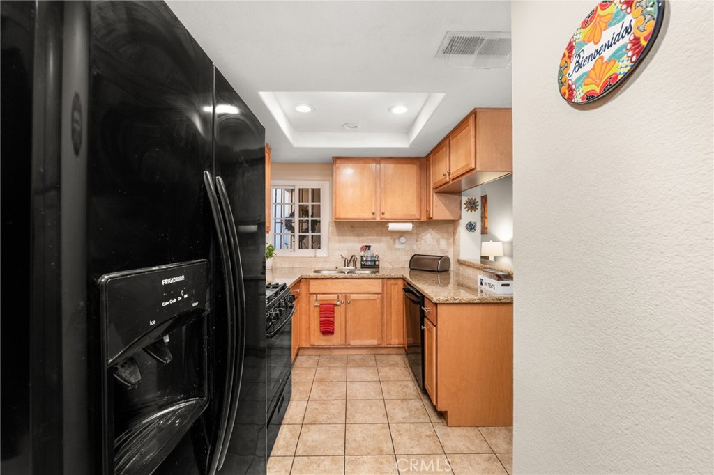 8576 Creekside Place Rancho Cucamonga, CA 91730 - Photo 13 of 37 a kitchen with stainless steel appliances granite countertop a refrigerator and a stove
