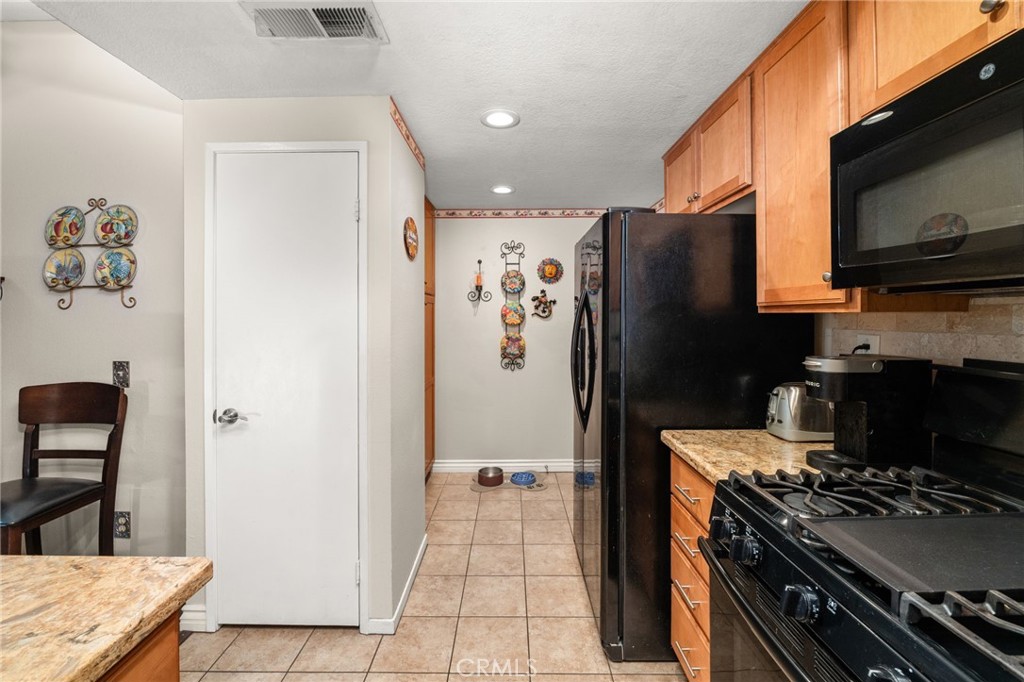 8576 Creekside Place Rancho Cucamonga, CA 91730 - Photo 14 of 37 a kitchen with a refrigerator and a stove