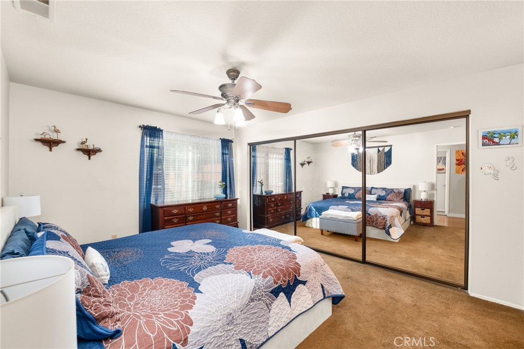 8576 Creekside Place Rancho Cucamonga, CA 91730 - Photo 18 of 37 a bedroom with a bed a chandelier and a couch