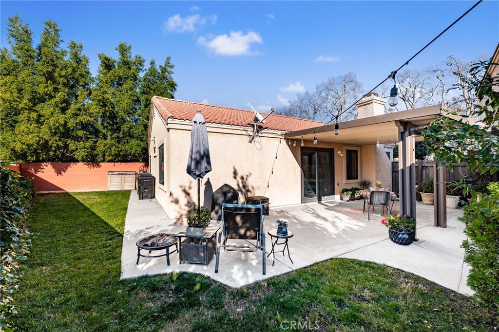 8576 Creekside Place Rancho Cucamonga, CA 91730 - Photo 27 of 37 a view of a patio with table and chairs potted plants and a large tree
