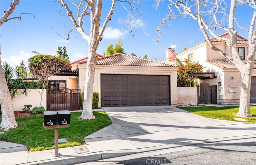 8576 Creekside Place Rancho Cucamonga, CA 91730 - Photo 3 of 37 a front view of a house with a garden and plants