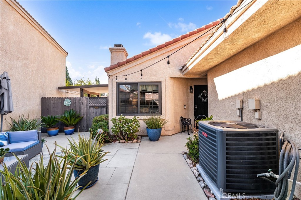 8576 Creekside Place Rancho Cucamonga, CA 91730 - Photo 5 of 37 a front view of a house with plants and chairs