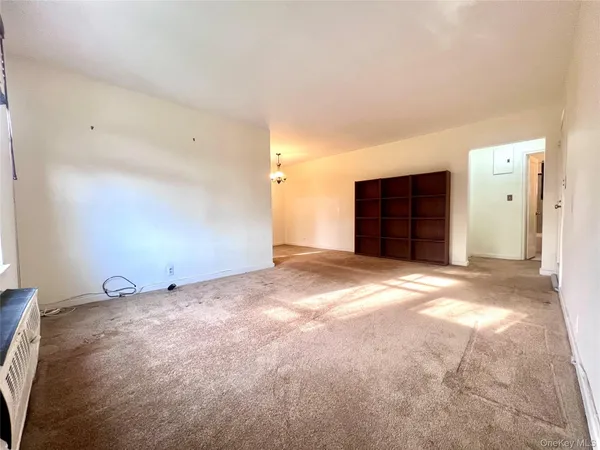 a view of an empty room with a cabinet