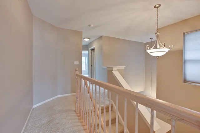 a view of a hallway with chandelier