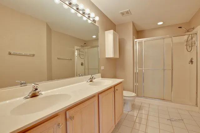 a bathroom with a sink double vanity and a mirror