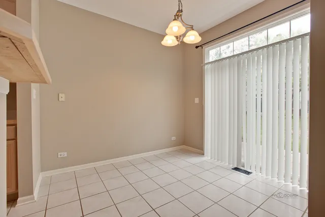 an empty room with chandelier fan
