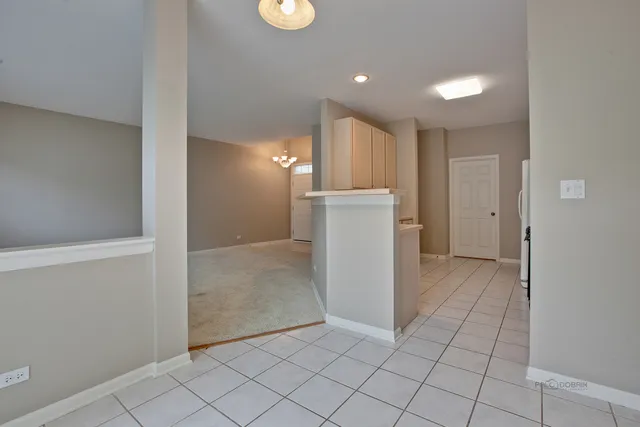 a view of a hallway with closet and utility room
