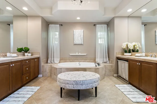 a spacious bathroom with a granite countertop sink and a mirror