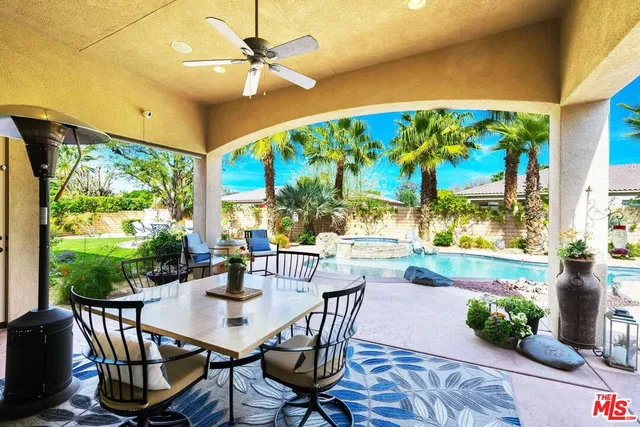 a dining room with furniture a garden and patio