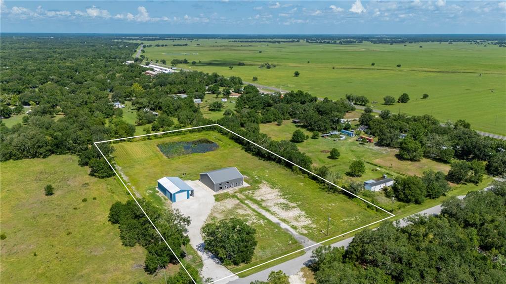 2593 Gene's Little Road Arcadia, FL 34266 - Photo 29 of 34 a view of a large pool with lawn chairs and plants