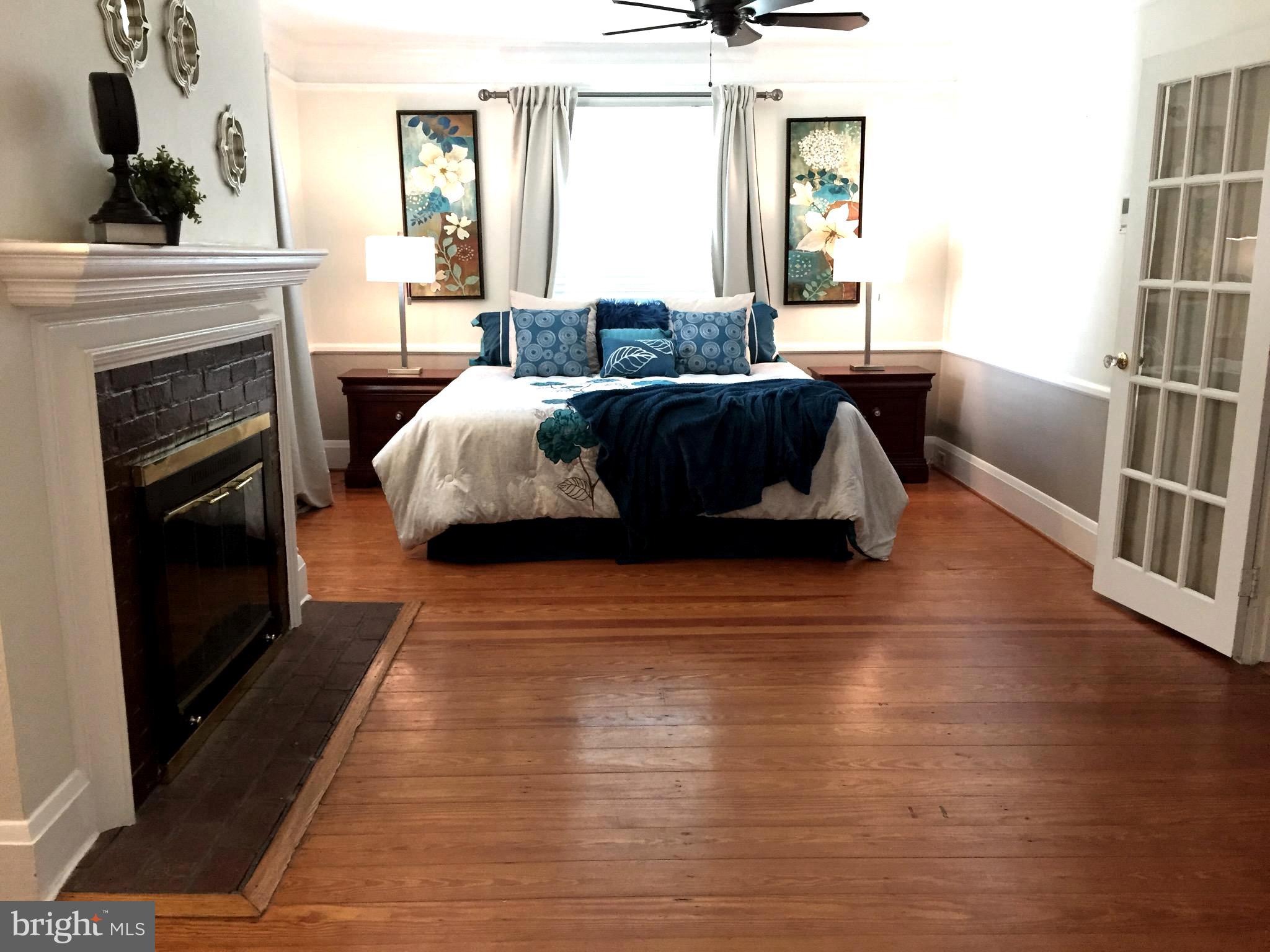 909 Kingston Road Baltimore, MD 21212 - Photo 27 of 47 Master bedroom with fireplace