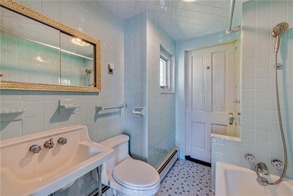 24 Butler Avenue Manor, PA 15665 - Photo 11 of 19 a bathroom with a sink a toilet and shower