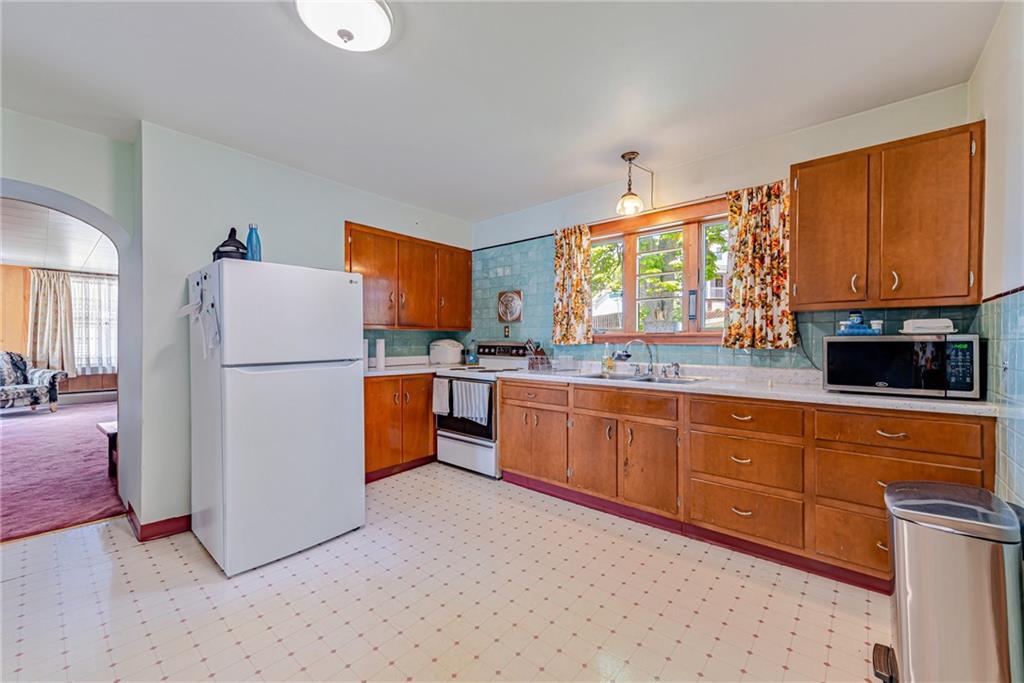 24 Butler Avenue Manor, PA 15665 - Photo 3 of 19 a kitchen with sink cabinets and refrigerator