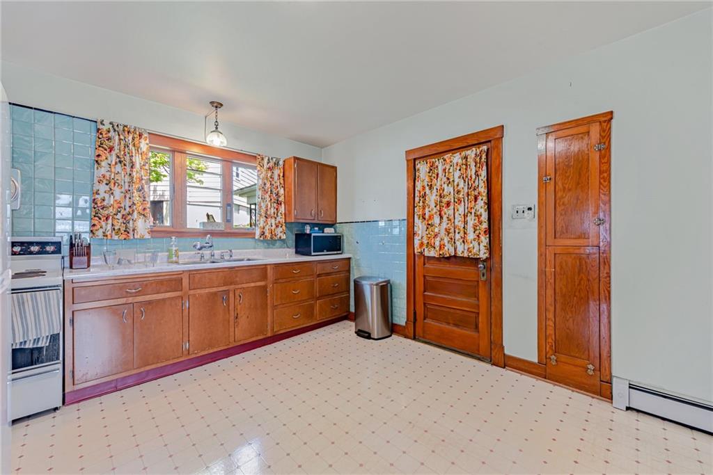 24 Butler Avenue Manor, PA 15665 - Photo 4 of 19 a kitchen with granite countertop a sink cabinets and window