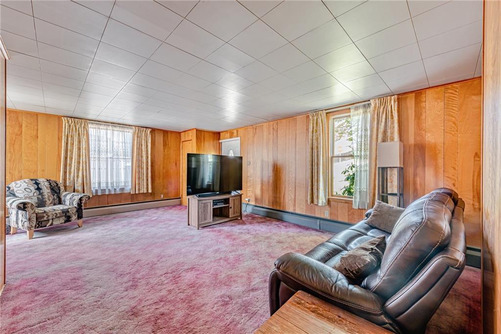 24 Butler Avenue Manor, PA 15665 - Photo 7 of 19 a living room with furniture a large window and a flat screen tv