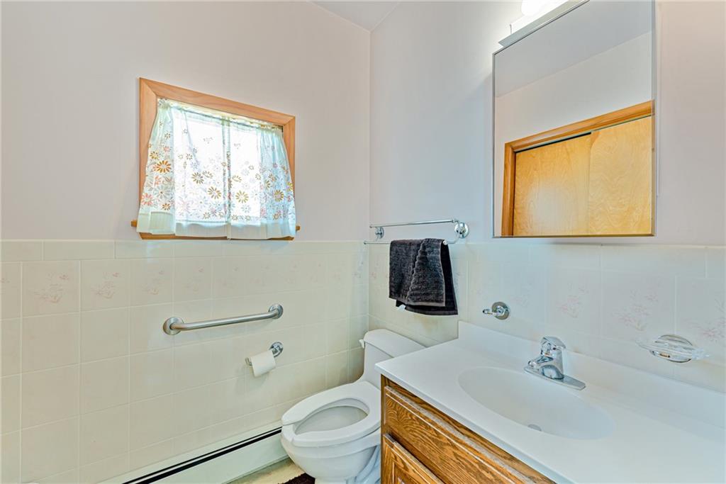 24 Butler Avenue Manor, PA 15665 - Photo 8 of 19 a bathroom with a sink a toilet and mirror