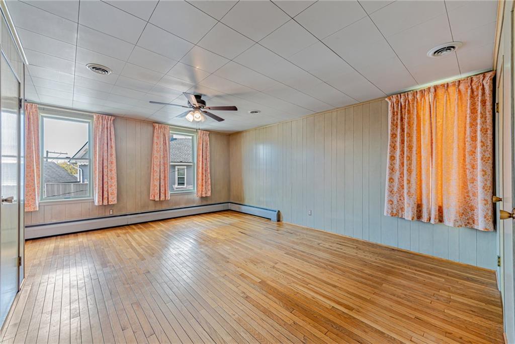 24 Butler Avenue Manor, PA 15665 - Photo 9 of 19 a view of an empty room with a window and wooden floor
