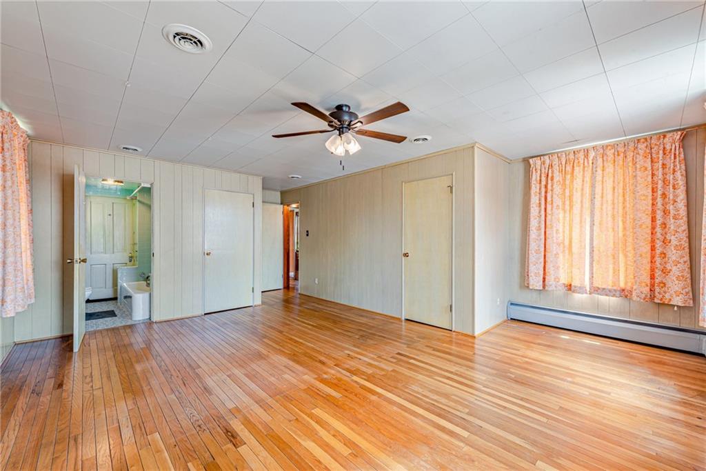 24 Butler Avenue Manor, PA 15665 - Photo 10 of 19 a view of an empty room with window and wooden floor