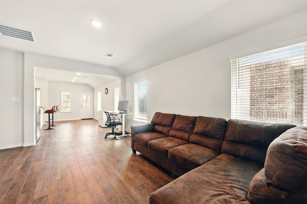 105 Musgrove Road Everman, TX 76140 - Photo 4 of 6 Living room with lofted ceiling, hardwood / wood-style flooring, and recessed lighting