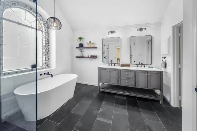 a bed sitting in a room next to a window