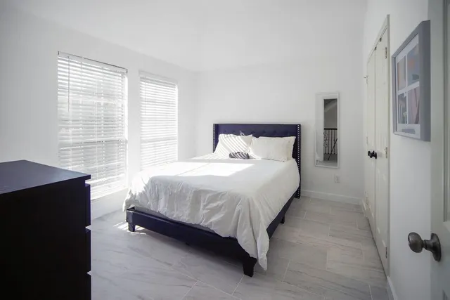 a bedroom with a bed and white walls