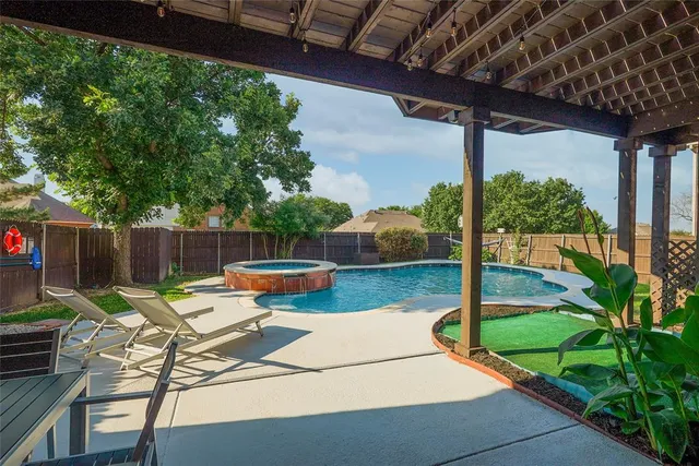 an aerial view of residential house with outdoor space and swimming pool