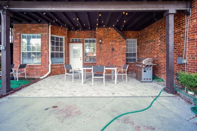 an aerial view of a house with a yard and large trees