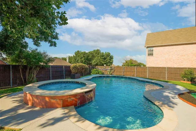 a small pool with lawn chairs next to yard