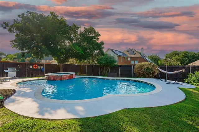 a view of a swimming pool with a yard