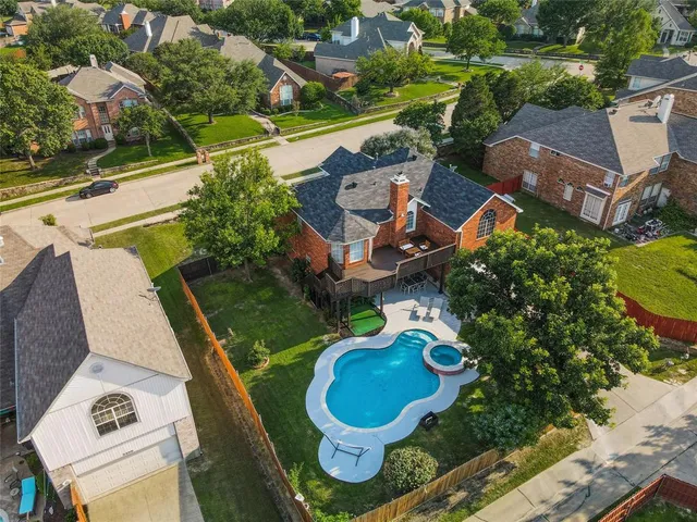 an aerial view of a house with swimming pool and ocean view