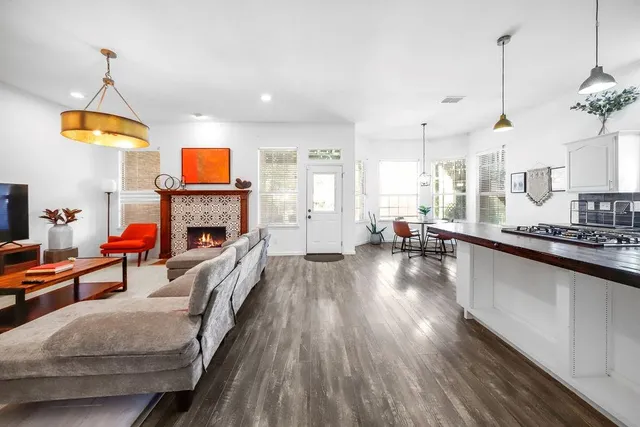 a living room with furniture a fireplace and a chandelier