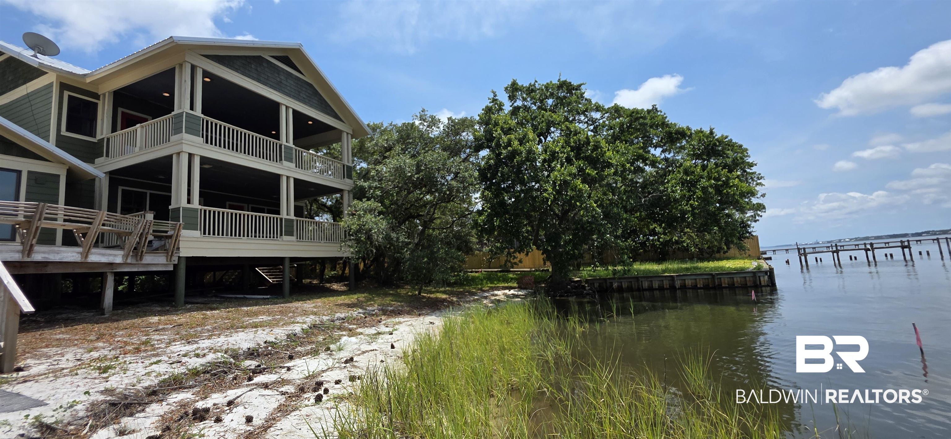 544 Windmill Ridge Road Gulf Shores, AL 36542 - Photo 1 of 50 The live oaks have been sculpted over decades to provide natural privacy and shade.
