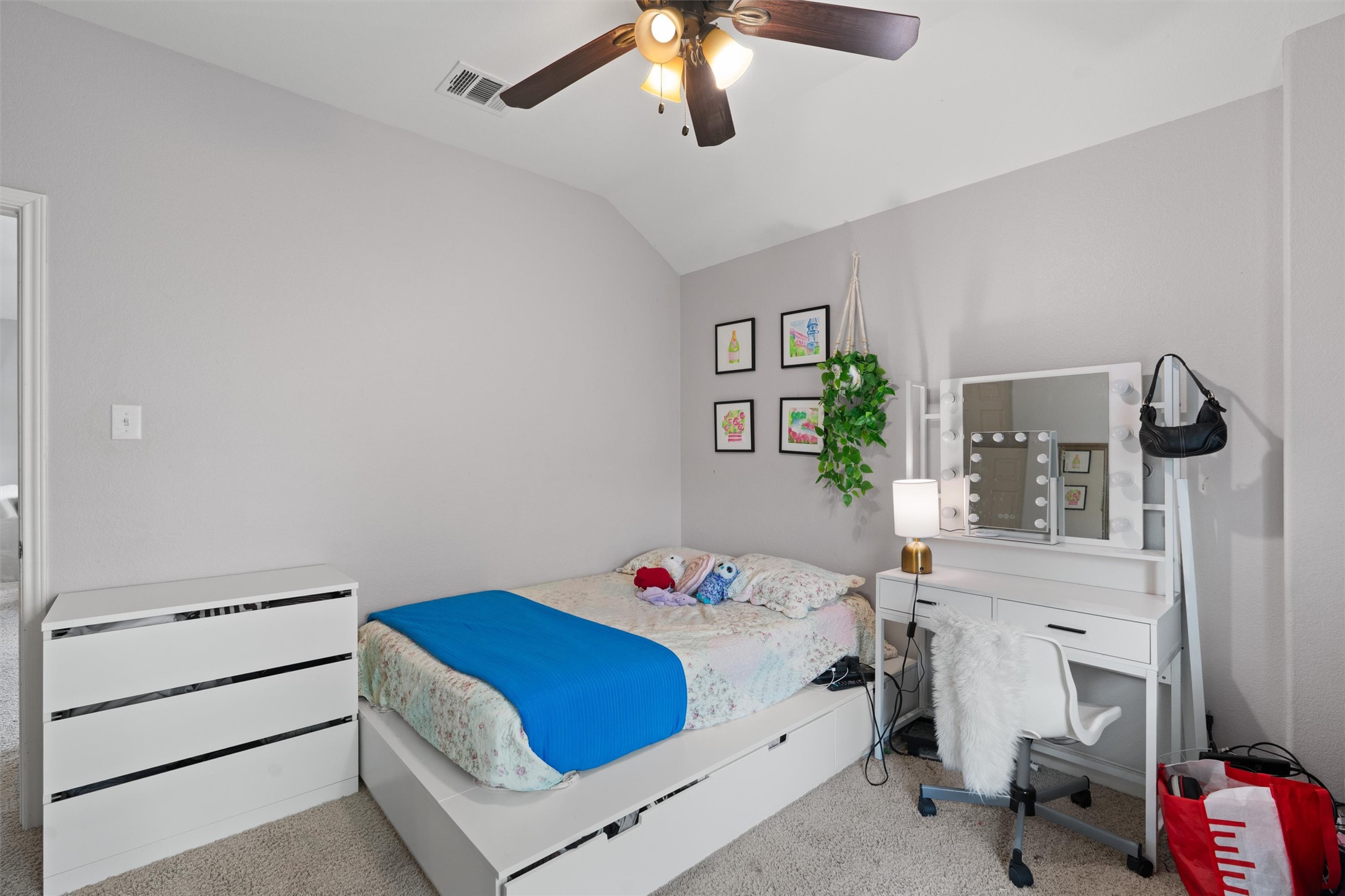 144 Copper Lake Lane Georgetown, TX 78628 - Photo 22 of 39 a bedroom with a bed and a chandelier