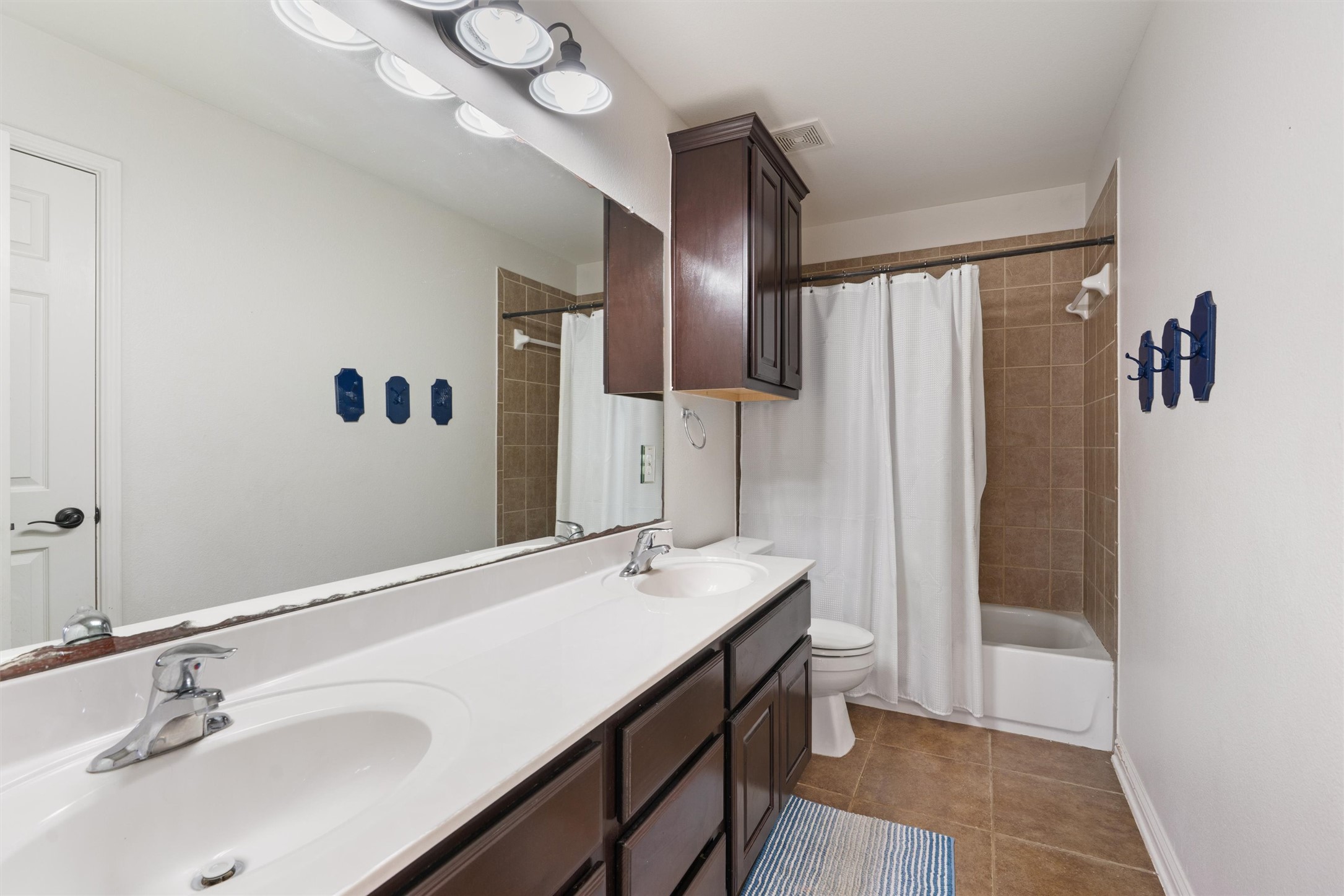 144 Copper Lake Lane Georgetown, TX 78628 - Photo 23 of 39 a bathroom with a sink a toilet and shower