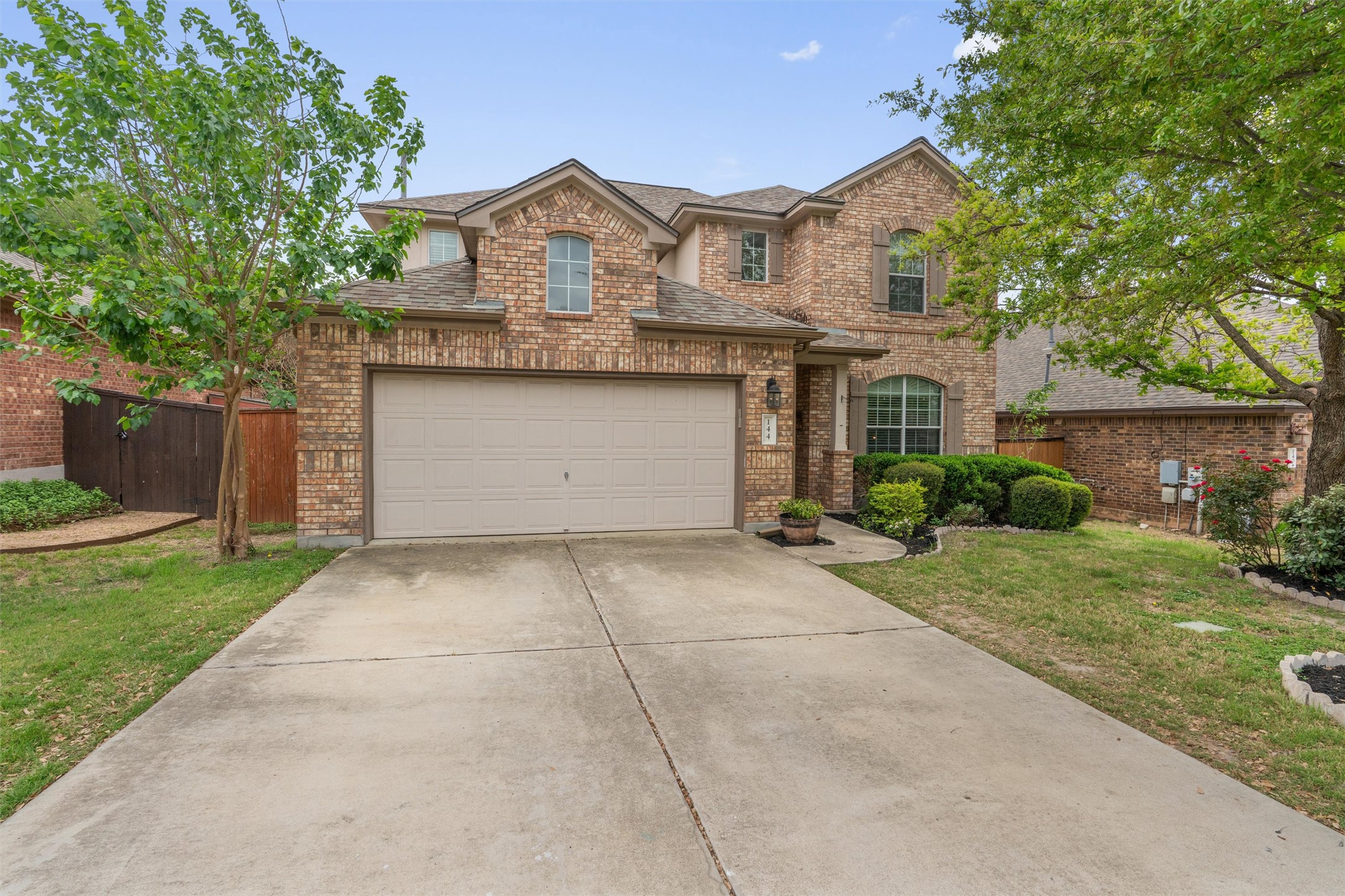 144 Copper Lake Lane Georgetown, TX 78628 - Photo 35 of 39 a front view of a house with a yard and a garage