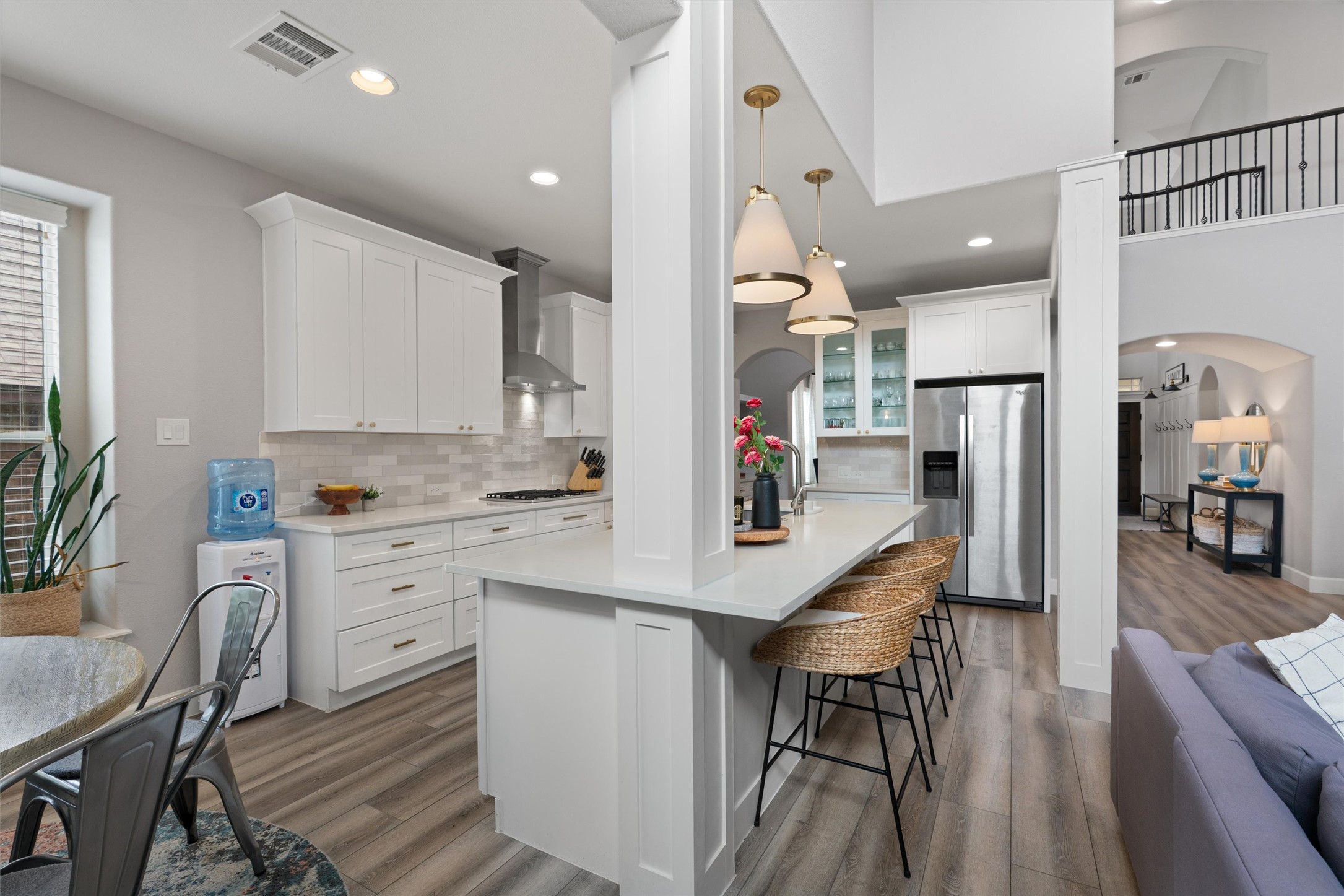 144 Copper Lake Lane Georgetown, TX 78628 - Photo 5 of 39 a kitchen with stainless steel appliances kitchen island granite countertop a table chairs refrigerator and sink