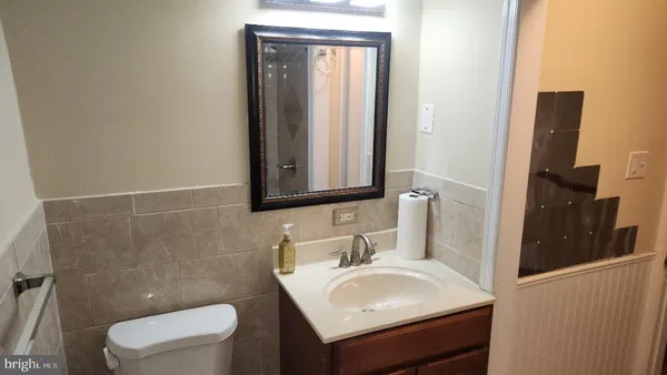 a bathroom with a sink toilet and vanity