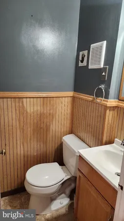 a white toilet sitting next to a shower