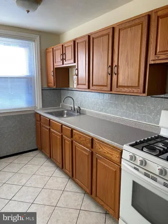 a kitchen with a cabinets and white stove top oven