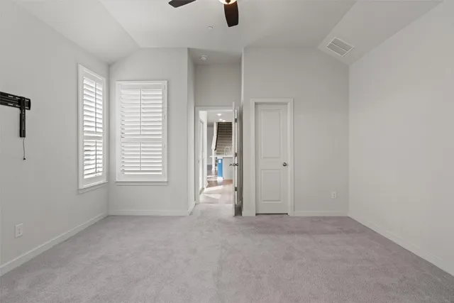 an empty room with windows and entrance