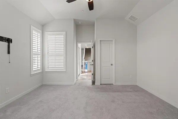 an empty room with windows and entrance