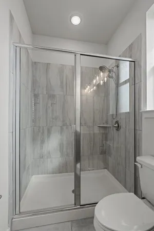 a bathroom with a shower and a toilet