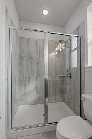 a bathroom with a shower and a toilet