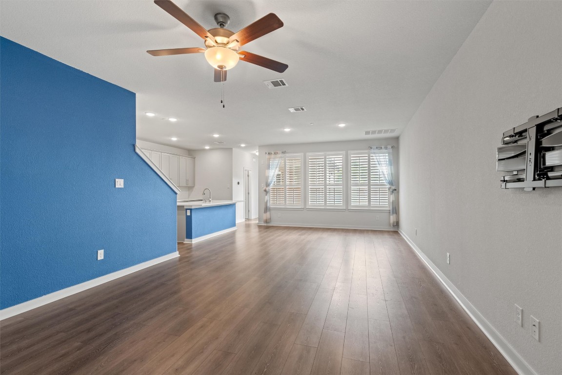 2500 Forest Creek Drive, Unit 302 Round Rock, TX 78665 - Photo 2 of 27 a view of an empty room with a window and wooden floor