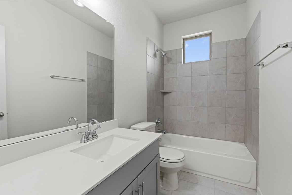 2500 Forest Creek Drive, Unit 302 Round Rock, TX 78665 - Photo 21 of 27 a bathroom with a sink a toilet and shower